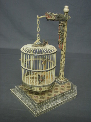 An Eastern carved bone model of a birdcage, raised on carved stand