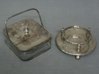 A rectangular glass and silver plated sardine dish with swing handle, a silver plated bottle/coaster frame