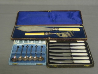 A pair of silver plated fish servers, cased, 6 tea knives with mother of pearl handles, 6 silver plated coffee spoons with bean end handles