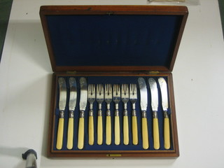 A set of 12 Victorian silver plated fish knives and forks contained in a walnut canteen box