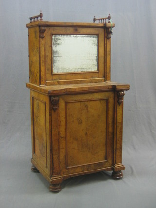 An unusual Victorian figured walnut Davenport with raised superstructure with bobbin turned decoration enclosed by mirrored panelled door to reveal pigeon holes and writing slope and sliding top, the pedestal fitted 4 drawers enclosed by a panelled door 25"