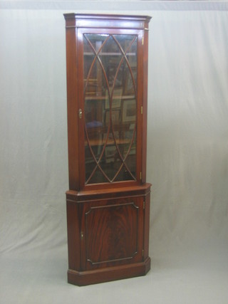 A good quality Georgian style mahogany double corner cabinet with moulded cornice, fitted shelves enclosed by astragal glazed panelled doors, the base fitted shelves enclosed by a panelled door 26"