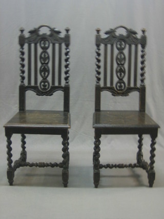 A pair of Victorian carved and ebonised high back hall chairs