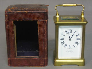 A 19th Century French 8 day carriage clock with enamelled dial and Roman numerals contained in a gilt metal case complete with original carrying case by Payne & Co 163 New Bond Street London