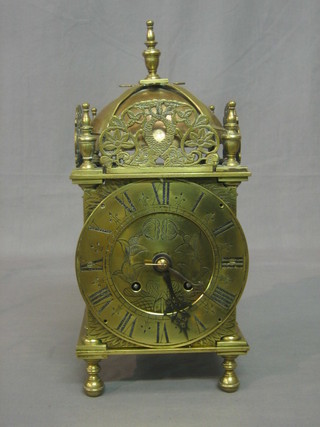 A Victorian brass striking lantern clock with Roman numerals, raised on bun feet 15"