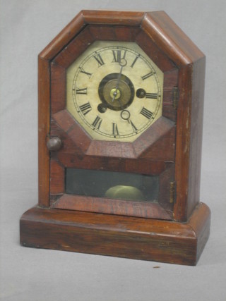 An American shelf alarm clock with painted dial and Roman numerals contained in a rosewood finished case
