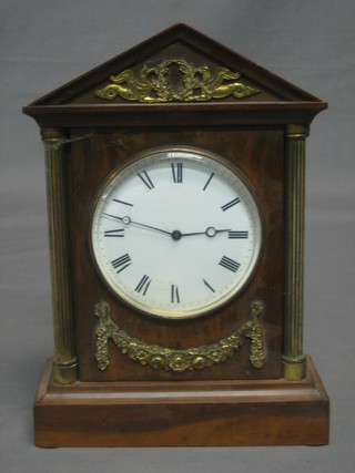A French mantel clock with porcelain dial and Roman numerals contained in a walnut Portico style case