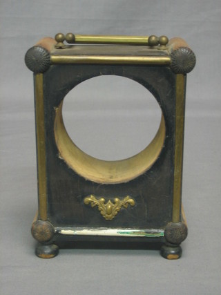 A 19th Century circular wooden clock case with brass carrying handle raised on bun feet 5"