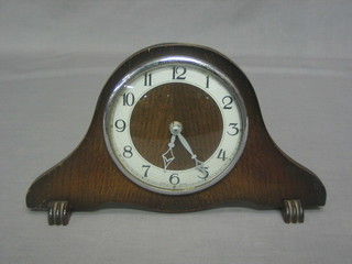 A 1950's 8 day mantel clock with silvered chapter ring and Roman numerals contained in an arch shaped oak case