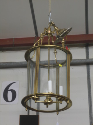 A circular 19th Century style brass and gilt metal hall lantern, the centre hung a 3 branch electrolier