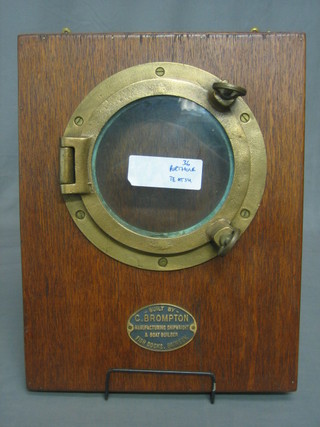 A circular brass porthole 8" mounted on a wooden panel with makers plate, marked built by C Brompton, the reverse marked MV TE-AT-SU labelled to reverse