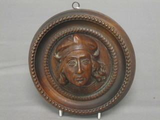 A  carved oak plaque decorated a Tudor gentleman contained in a circular boss 6 1/2"