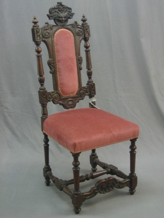 A Victorian high back carved oak hall chair, the seat and back upholstered in pink material (old break to back), raised on turned and block supports