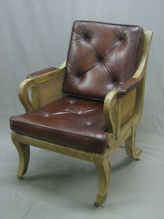 A handsome Regency style single can bergere library chair with leather arms