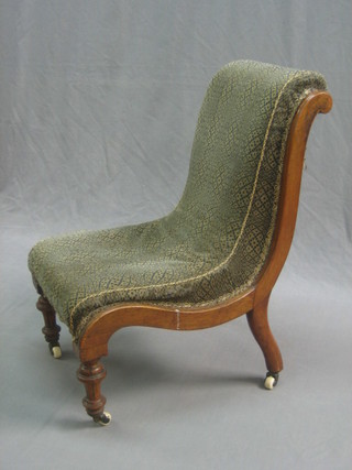 A Victorian mahogany show frame nursing chair upholstered in blue material