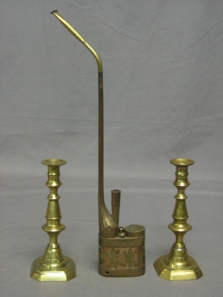 An Eastern brass opium pipe and a pair of 19th Century brass candlesticks 7"