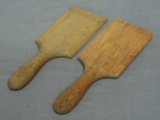 A pair of wooden butter pats