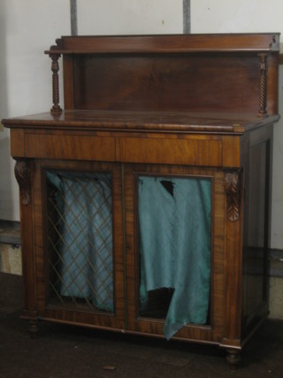 A Regency mahogany chiffonier with raised back, the base fitted 2 drawers with cupboard enclosed by grilled panelled doors, raised on turned supports 40"