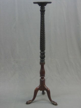 An Edwardian turned mahogany bed post torchere raised on cabriole supports