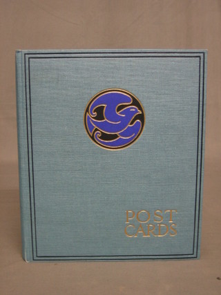 A blue card album containing a collection of postcards