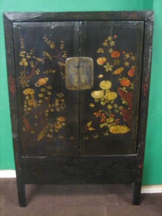 An Oriental black lacquered and floral patterned "marriage" cabinet enclosed by panelled doors 46"