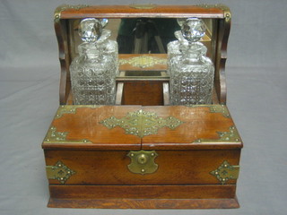 An oak and silver plated tantalus complete with 2 hobnail cut spirit decanters 13 1/2" (no key)