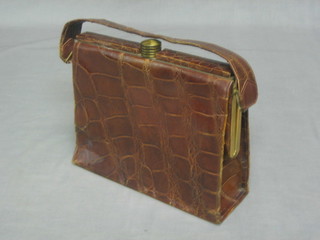 A rectangular crocodile handbag with gilt metal mounts 9"