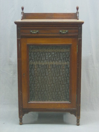 An Edwardian walnut music cabinet with three-quarter gallery fitted a drawer, the interior fitted shelves enclosed by a glazed door 23"