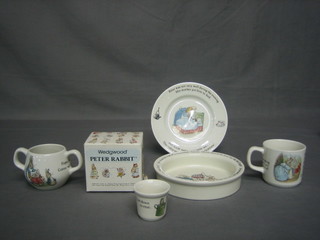A Wedgwood Peter Rabbit plate, do. bowl, do. twin handled mug, do. mug, money box and egg cup