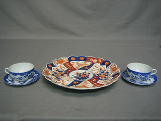 A circular Japanese Imari porcelain plate with lobed border and floral decoration 12" and 2 late Japanese blue and white egg shell porcelain cups and saucers
