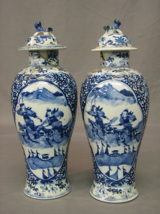 A pair of Oriental blue and white porcelain urns and covers, the bases with 4 character marks 13" (f)