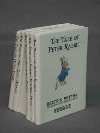 A Wedgwood Peter Rabbit money box in the form of 5 stacked books 5"