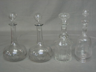 A pair of Victorian cut glass club shaped decanters and 2 other decanters