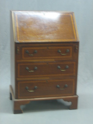 An Edwardian inlaid mahogany bureau the fall front revealing a well fitted interior above 3 long drawers raised on bracket feet 24"