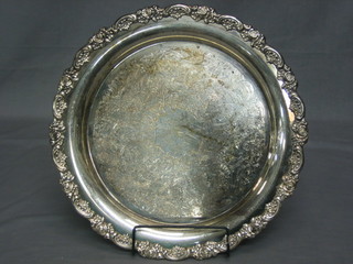 A circular silver plated salver with cast floral border and engraved decoration 15"