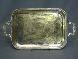 A silver plated twin handled tea tray with gadrooned border 23"