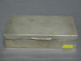 A rectangular silver cigarette box with hinged lid Birmingham 1950, 7"