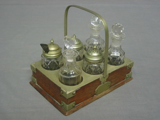 An oak and silver plated 6 bottle cruet, having 6 cut glass bottles with plated mounts