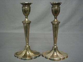 A pair of Adam style silver candlesticks with detachable sconces, raised on a waisted bases, Birmingham 1969, 12"