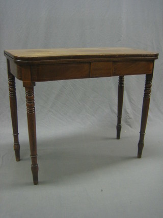 A 19th Century mahogany D shaped tea table raised on turned supported 36"