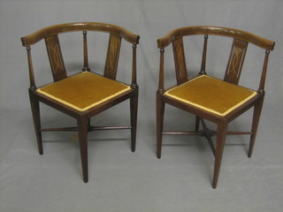 A pair of Edwardian inlaid mahogany corner chairs, raised on turned supports