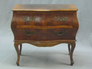 A 20th Century walnut commode of bombe form fitted 2 long drawers, raised on cabriole supports 29"