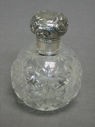 A circular cut glass perfume bottle of globular form with silver lid, London 1900