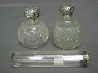 A cut glass pin jar with silver lid together with 2 circular cut glass perfume bottles with silver lids