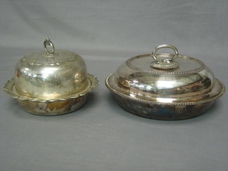 A circular silver plated entree dish and cover and a muffin dish and cover