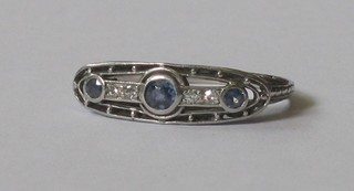 An 18ct white gold dress ring set 3 circular cut sapphires supported by diamonds