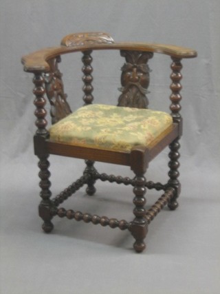 A Victorian carved oak corner chair with bobbin turned decoration