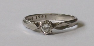 An 18ct white gold dress ring set a solitaire diamond
