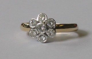 An 18ct gold 7 stone diamond cluster dress ring
