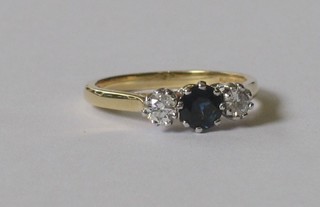 An 18ct dress ring set a sapphire supported by diamonds